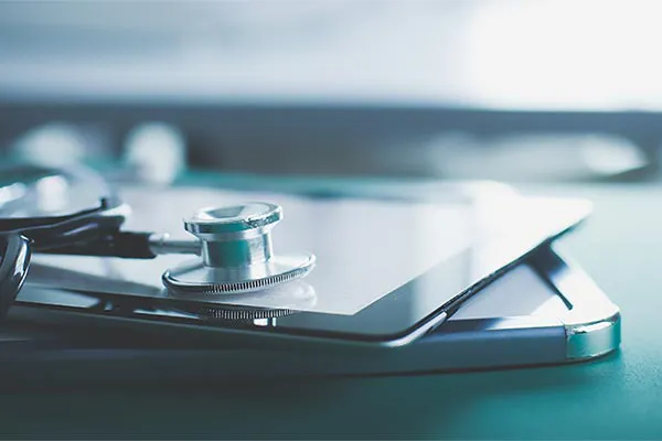 Close up of a stethoscope lying on a tablet, representing advanced functional medicine testing offered by The Cove Concierge Medicine in Denver.