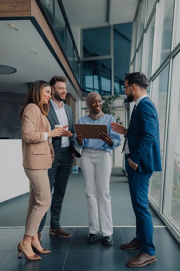A group of healthy, focused executives happily meeting in a lobby. Schedule concierge primary care for executives from The Cove Concierge Medicine in Denver.